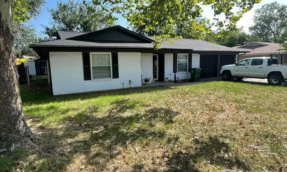 Professional roofing crew working on a residential roof in Newton